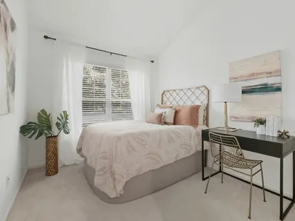 a bedroom with a bed and window