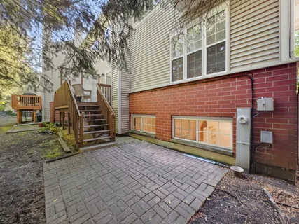a view of house with backyard and trees