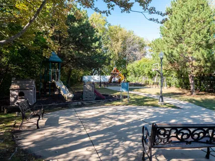 a view of a park with iron fence