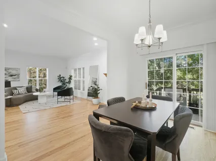 a view of a dining room with furniture wooden floor and chandelier