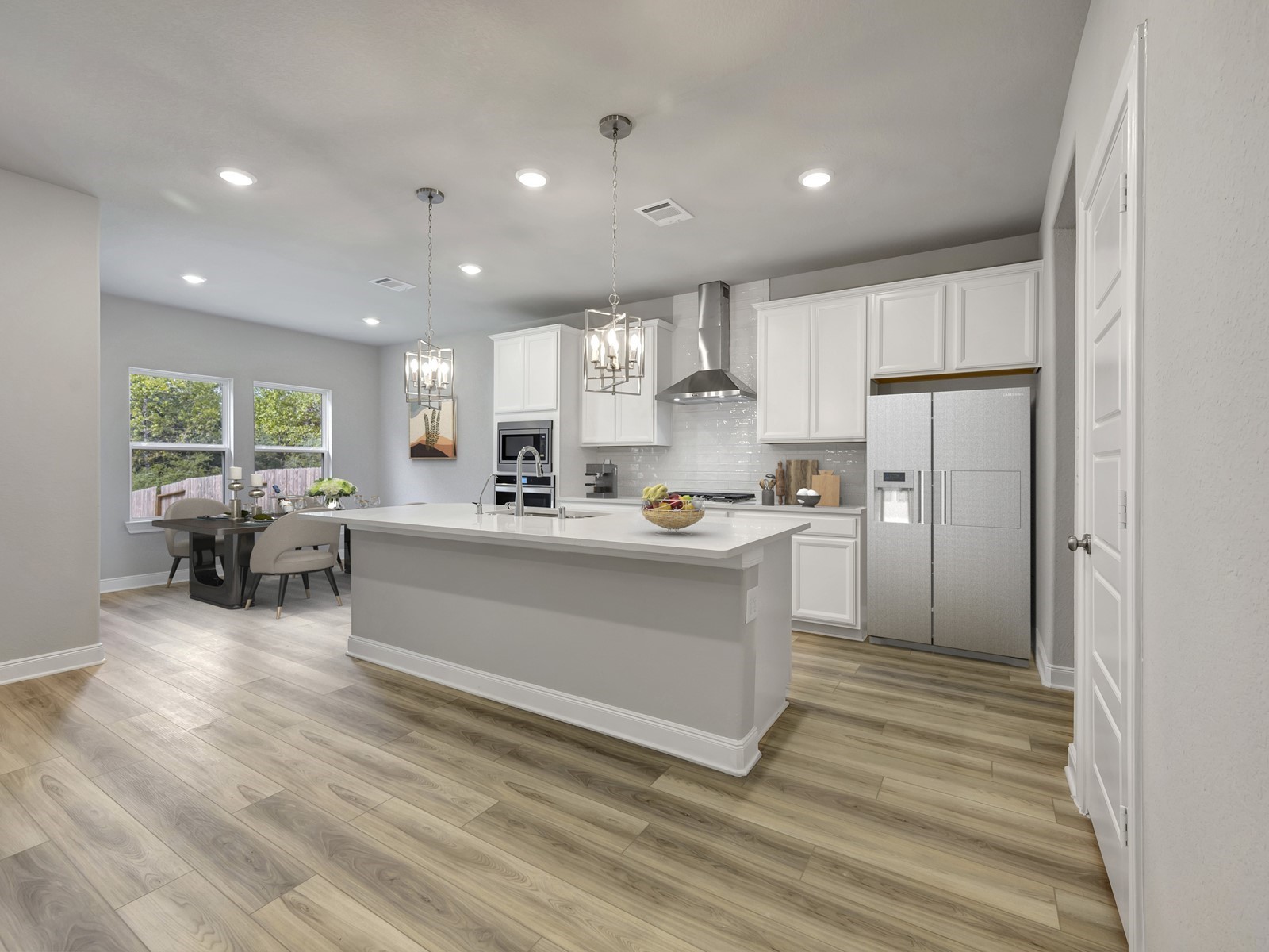1645 Hopson Ranch Drive Conroe, TX 77301 - Photo 2 of 33 a view of kitchen center island cabinets and stainless steel appliances
