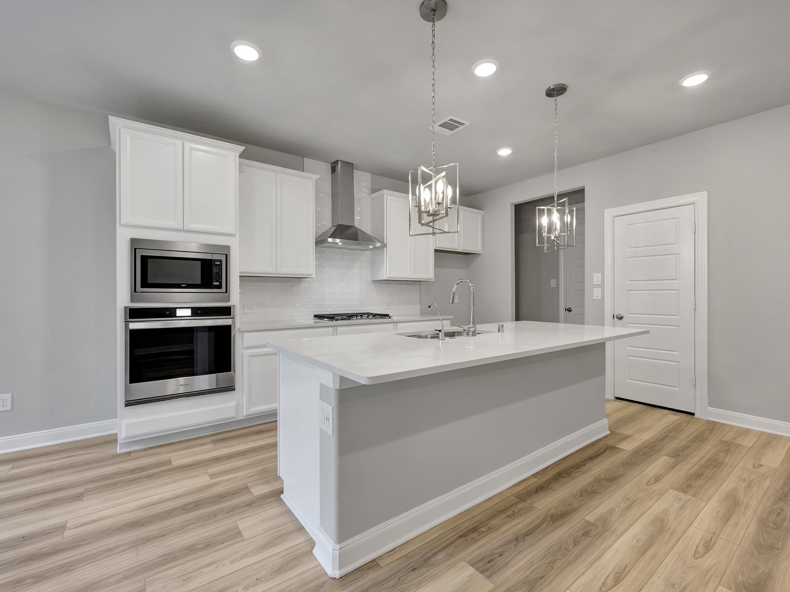 1645 Hopson Ranch Drive Conroe, TX 77301 - Photo 3 of 33 a large kitchen with kitchen island a sink stainless steel appliances and cabinets