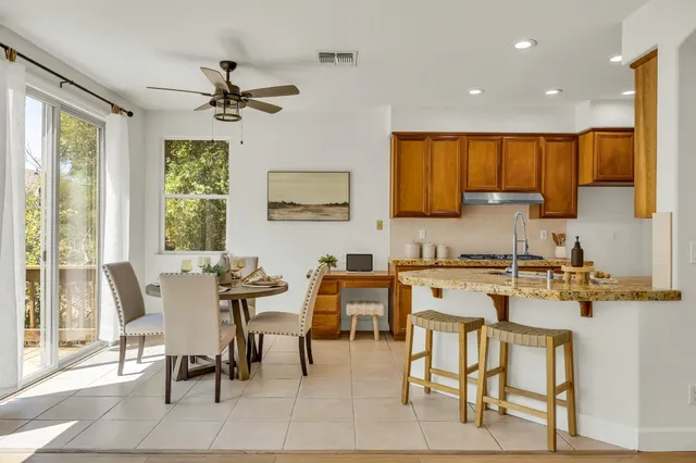 a living room with furniture a large window and a fireplace