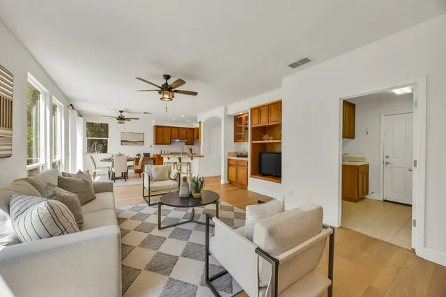 a view of a hallway with wooden floor and staircase
