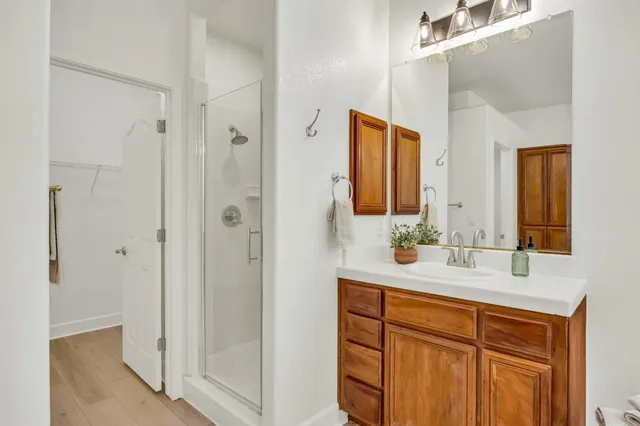 a balcony with wooden floor and outdoor seating