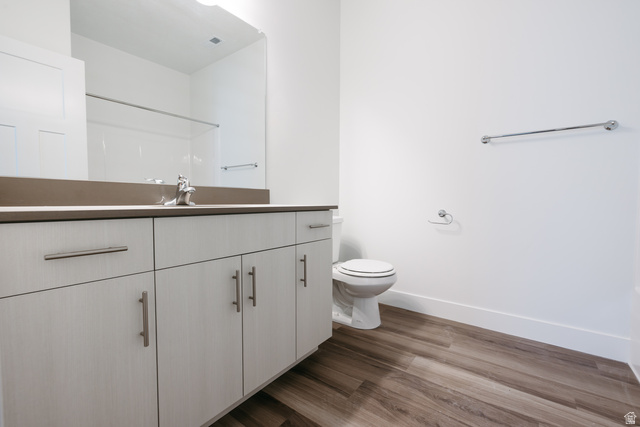 4653 South Alder Drive, Unit H304 Mapleton, UT 84664 - Photo 11 of 14 Bathroom featuring vanity, dark wood-style flooring, and a shower