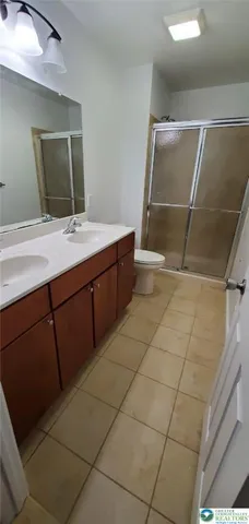 a bathroom with a double vanity sink and mirror