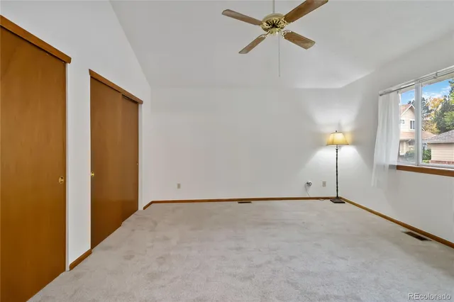 a view of empty room with ceiling fan