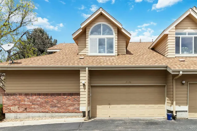 a front view of a house with garage
