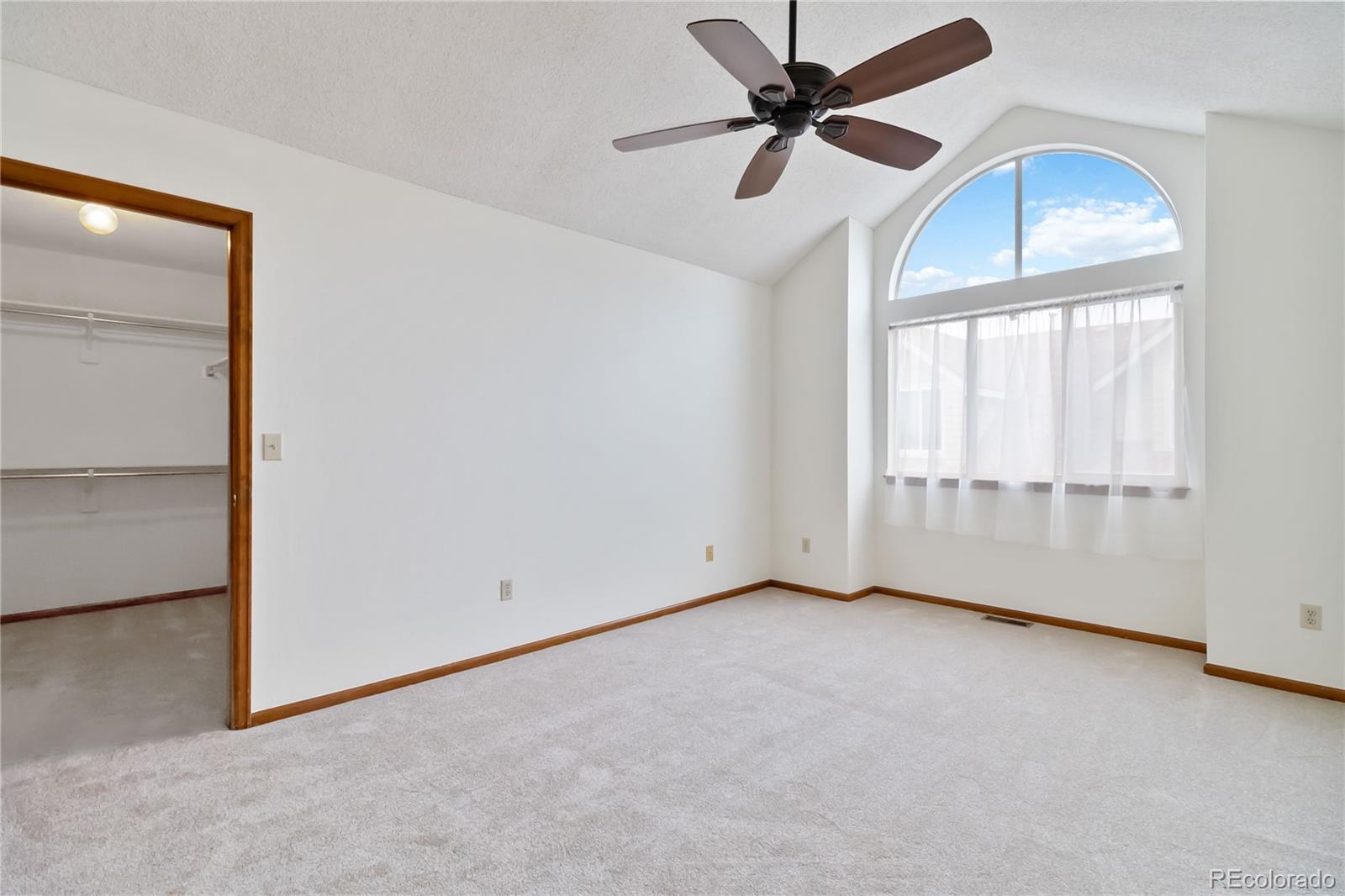 2136 South Scranton Way Aurora, CO 80014 - Photo 9 of 22 an empty room with chandelier fan and windows