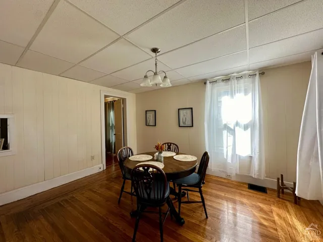 a view of a dining room with furniture and window
