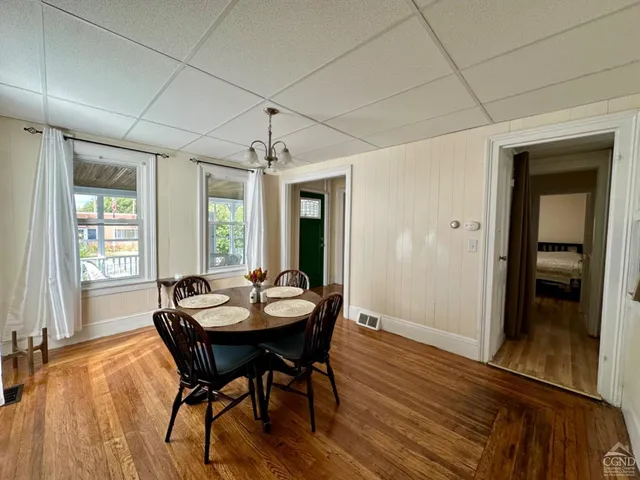 a view of a dining room with furniture window and wooden floor
