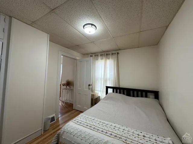 a bedroom with a bed and a window