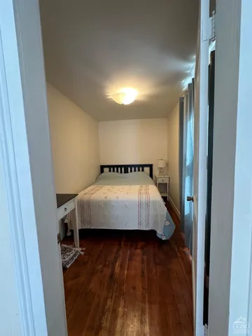 a bed sitting in a room next to a window