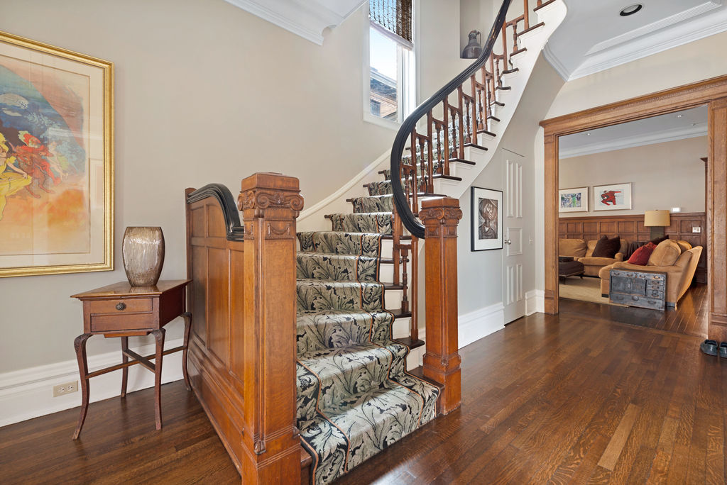643 West Deming Place Chicago, IL 60614 - Photo 27 of 44 a view of a hallway with wooden floor and stairs