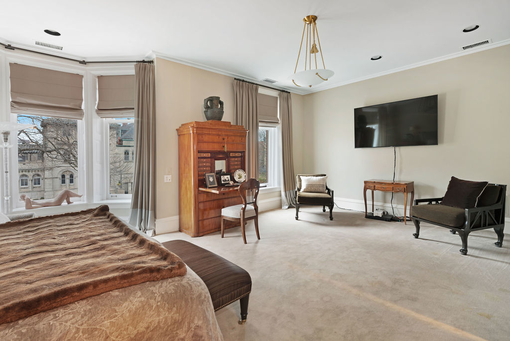 643 West Deming Place Chicago, IL 60614 - Photo 29 of 44 a spacious bedroom with a bed a couch and a flat screen tv