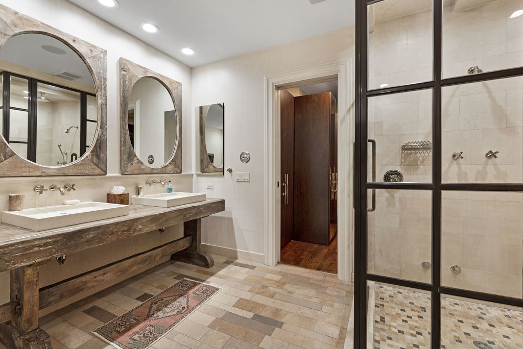 643 West Deming Place Chicago, IL 60614 - Photo 30 of 44 a bathroom with a double vanity sink a mirror and shower