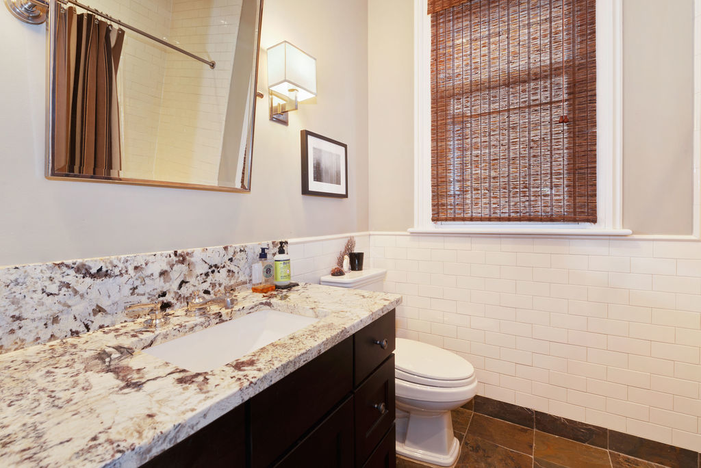 643 West Deming Place Chicago, IL 60614 - Photo 33 of 44 a bathroom with a granite countertop sink a toilet and a mirror