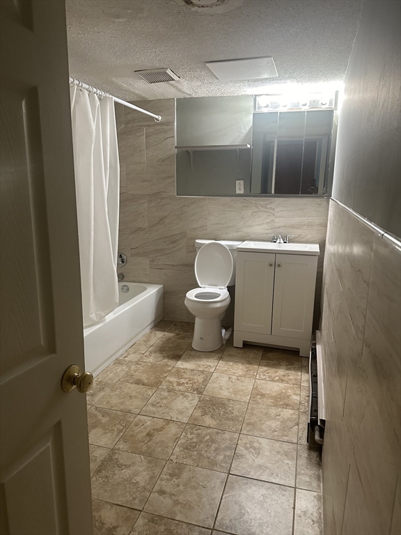 57 Brighton Avenue, Unit B Boston, MA 02134 - Photo 16 of 17 a bathroom with a sink and mirror