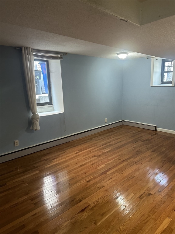 57 Brighton Avenue, Unit B Boston, MA 02134 - Photo 8 of 17 a view of a room with wooden floor and window