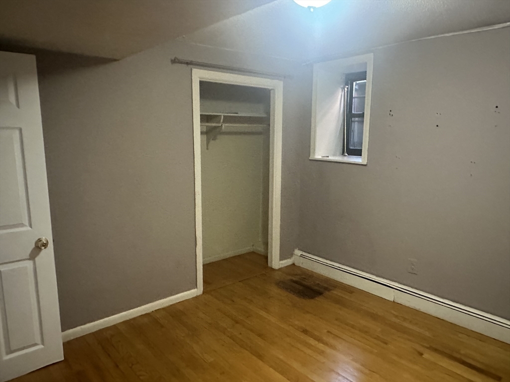 57 Brighton Avenue, Unit B Boston, MA 02134 - Photo 9 of 17 an empty room with closet and a window