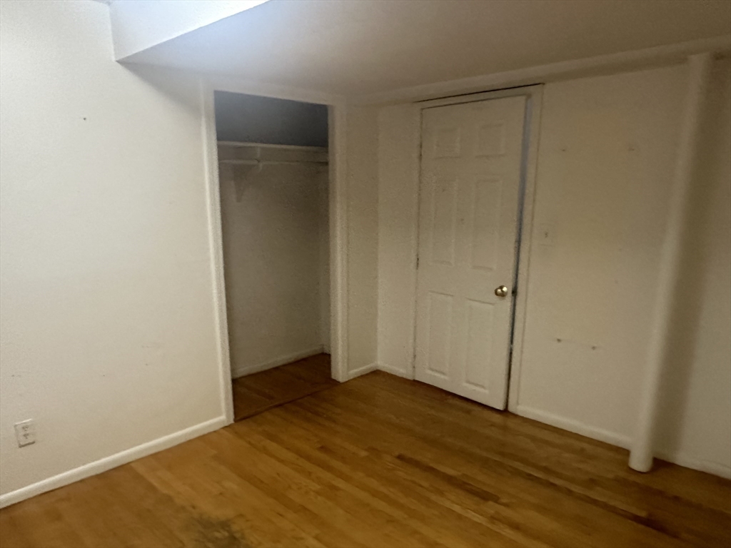 57 Brighton Avenue, Unit B Boston, MA 02134 - Photo 10 of 17 an empty room with wooden floor and closet