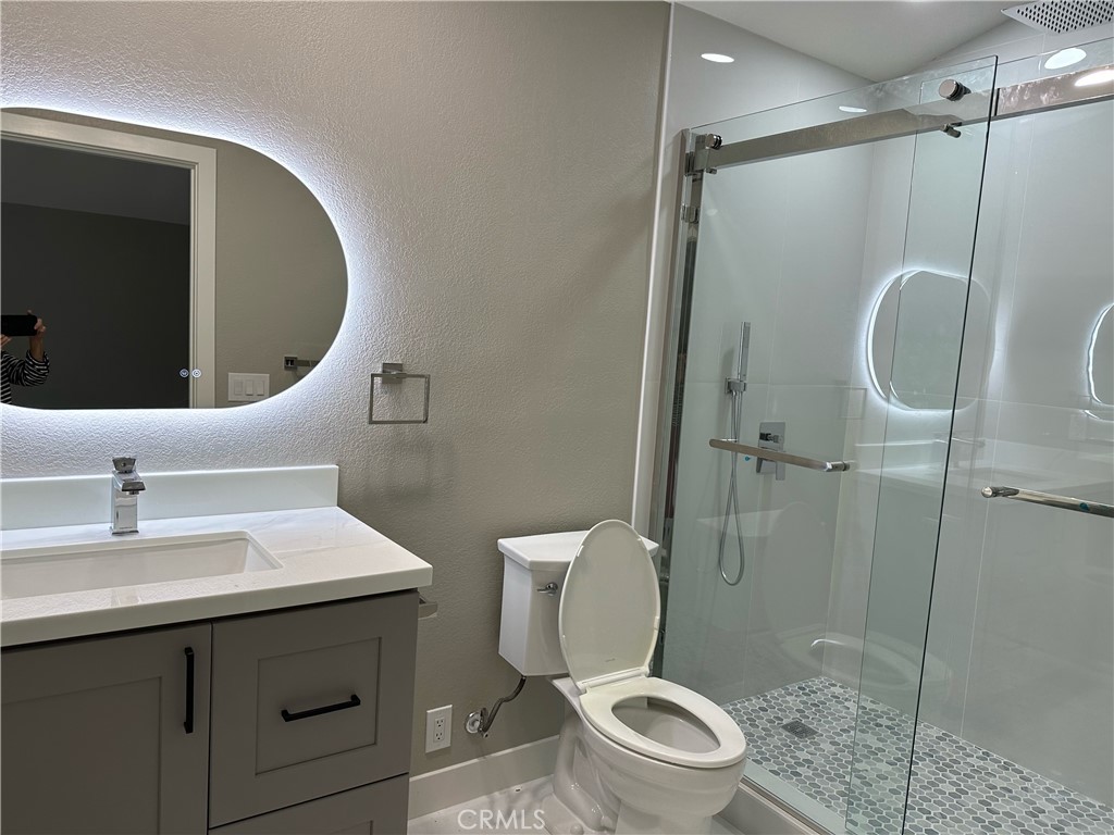 24746 Scott Lane Lake Forest, CA 92630 - Photo 3 of 4 a bathroom with a sink toilet and shower