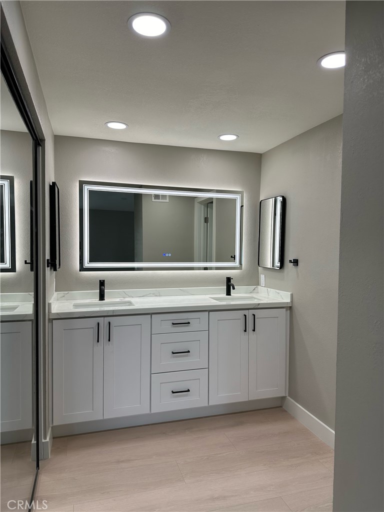 24746 Scott Lane Lake Forest, CA 92630 - Photo 4 of 4 a bathroom with double sink and mirror