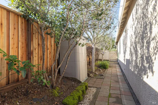 a backyard of a house with table and chairs