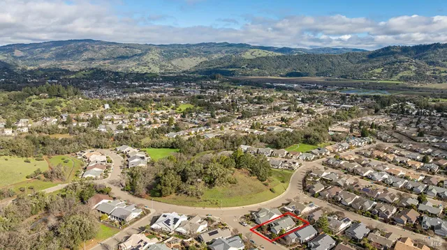an aerial view of residential house with green space
