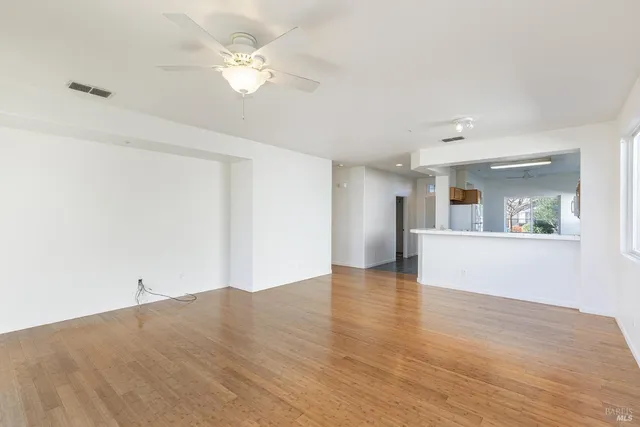 a view of a kitchen with wooden floor and a kitchen space
