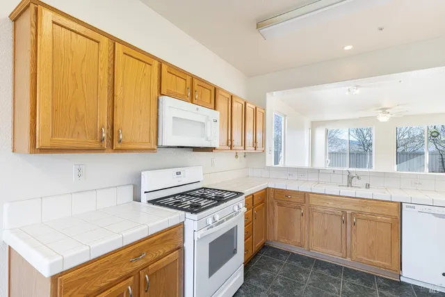 a view of a kitchen with a sink and refrigerator