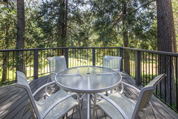 a balcony with table and chairs