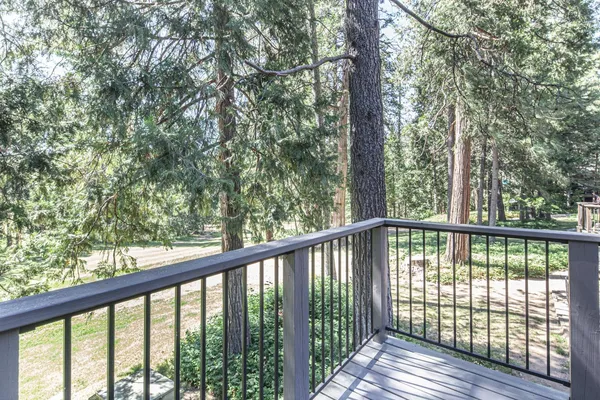 a view of a wooden deck next to a yard