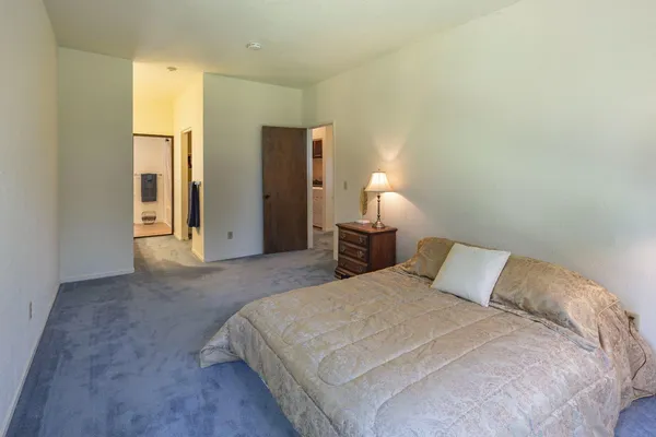 a bed sitting in a bedroom next to a window