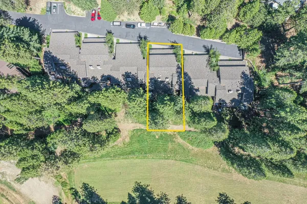 an aerial view of a house with a yard