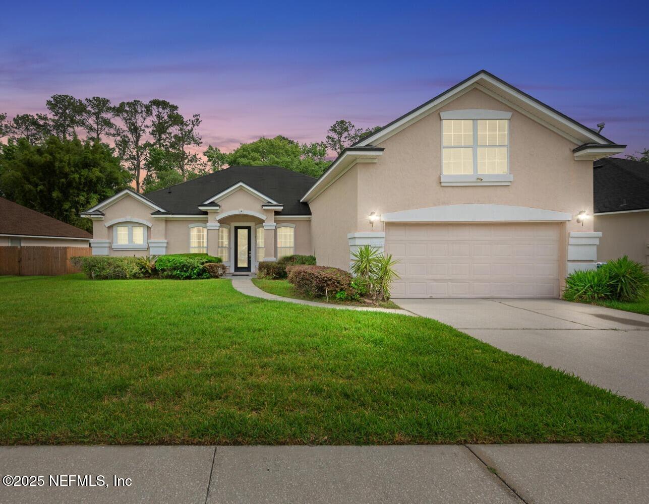 4219 Woodley Creek Road Jacksonville, FL 32218 - Photo 1 of 28 a front view of a house with a yard and garage