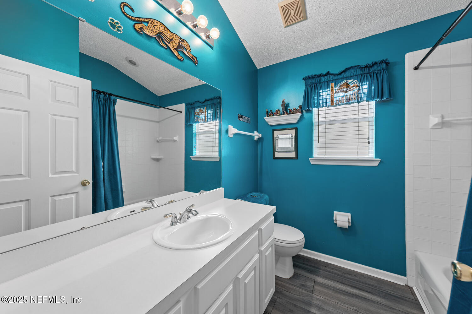 4219 Woodley Creek Road Jacksonville, FL 32218 - Photo 17 of 28 a bathroom with a sink a toilet and mirror