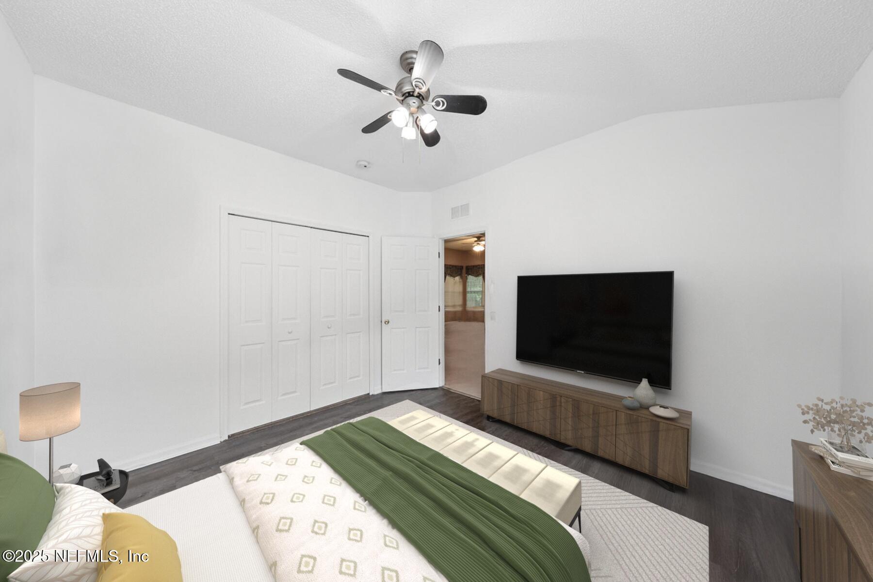 4219 Woodley Creek Road Jacksonville, FL 32218 - Photo 18 of 28 a bedroom with bed and flat screen tv