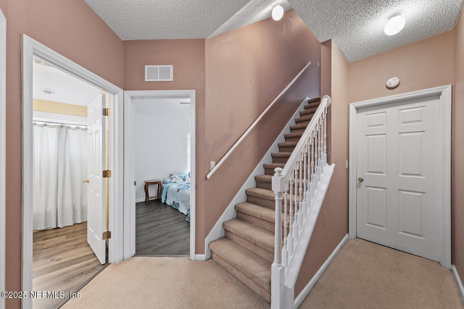 4219 Woodley Creek Road Jacksonville, FL 32218 - Photo 20 of 28 a view of a hallway with staircase and white walls