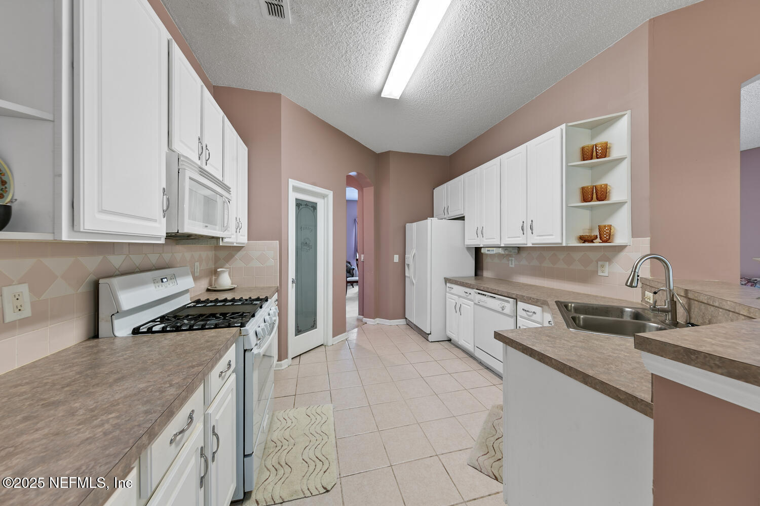 4219 Woodley Creek Road Jacksonville, FL 32218 - Photo 8 of 28 a kitchen with stainless steel appliances granite countertop a stove a sink and a refrigerator