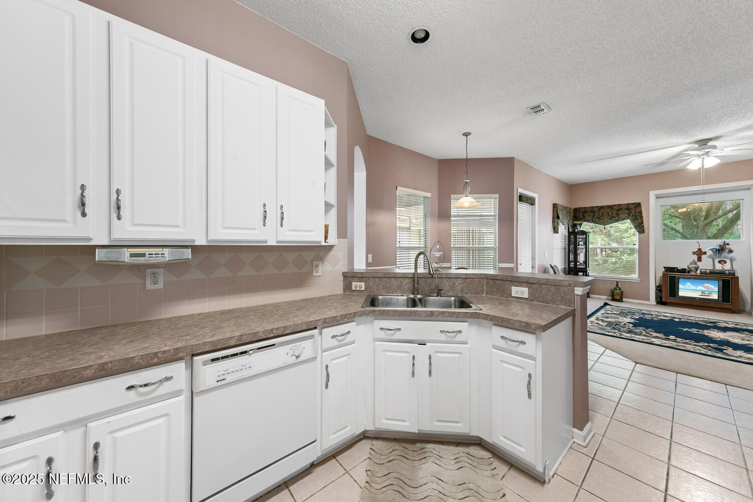 4219 Woodley Creek Road Jacksonville, FL 32218 - Photo 9 of 28 a kitchen with granite countertop white cabinets and white appliances