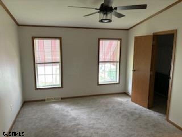 1621 Highway 9 Palermo, NJ 08230 - Photo 8 of 13 an empty room with a window and a ceiling fan