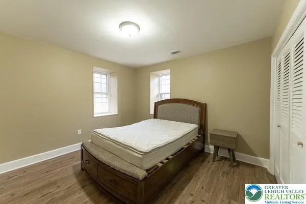 a room with a bed and window
