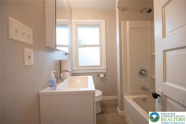 a bathroom with a sink a toilet and tub