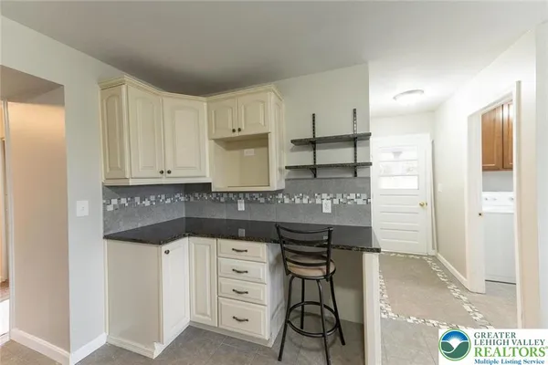 a kitchen with granite countertop a sink and cabinets