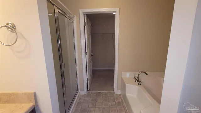 a spacious bathroom with a double vanity sink and a mirror