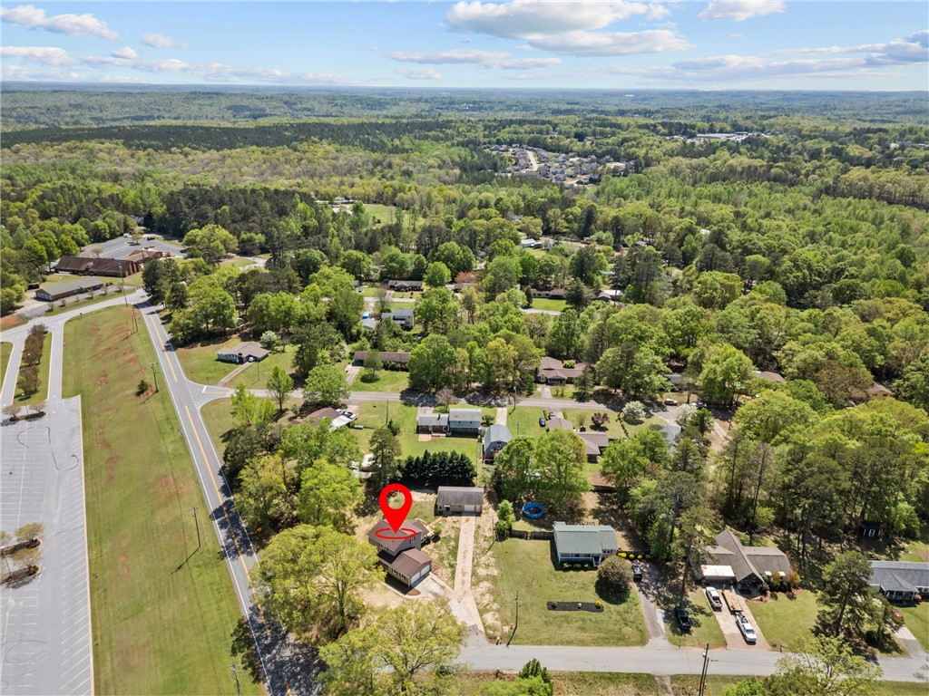 101 Maria Lane Seneca, SC 29678 - Photo 30 of 31 An aerial view captures the neighborhood with lush trees and a distant road.