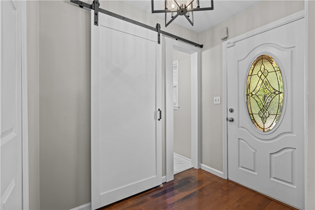 101 Maria Lane Seneca, SC 29678 - Photo 5 of 31 This inviting entrance features rich hardwood flooring and a stylish barn door leading to an adjacent room.