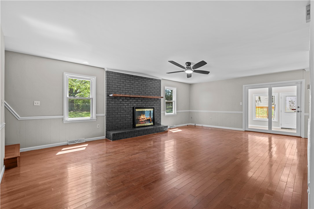 101 Maria Lane Seneca, SC 29678 - Photo 7 of 31 This inviting living space features gleaming hardwood floors and a striking fireplace, perfect for cozy gatherings.